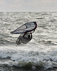 windsurfer hitting a wave
